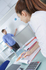 tudents in a classroom listening to teacher