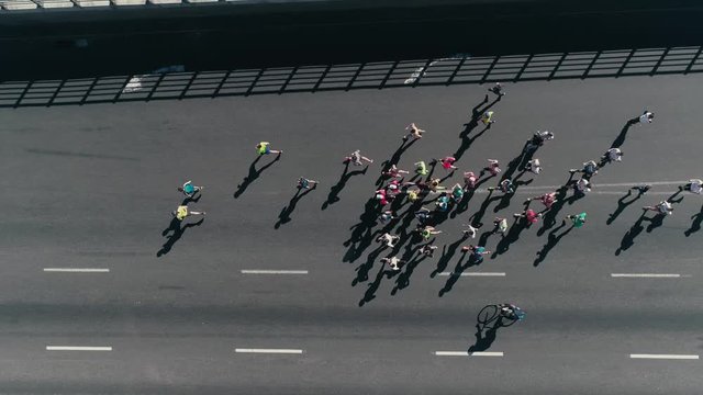 4k Aerial drone fooage. Marathon running on street. Following Group of athletes. Top view