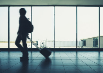 Fototapeta na wymiar Traveler walking with Luggage arrival Terminal Airport People Travel concept