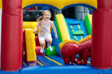 Child jumping on playground trampoline. Kids jump.