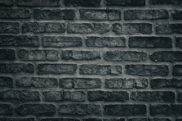 Dark gray brick wall close-up texture - rough brickwork background