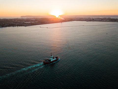 Aerial Photo Of A Small Tugboat At Sunset