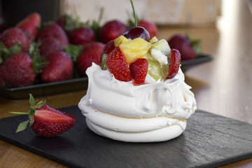 Restaurant dessert - Anna Pavlova meringue with low-fat whipped cream and strawberry