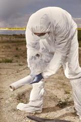 Police technician packing human skull found on plain construction yard during work