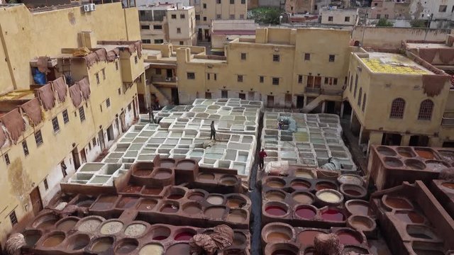 Panorama of tanneries in Fes, Morocco, Africa. Old tanks with color paint for leather, 4k