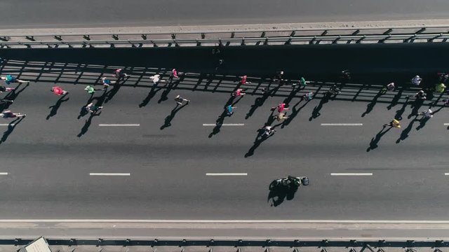 4K Aerial drone fooage. Marathon running on street. Group of athletes. Top view