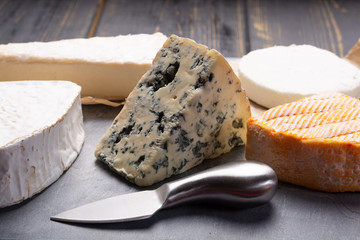French cheeses plate in assortment, blue cheese, brie, munster, soft goat cheese, Neufchatel