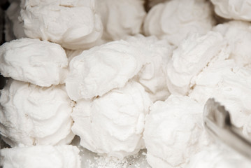 Marshmallows on a shelf in a supermarket. Lots of round marshmallows. Soft focus
