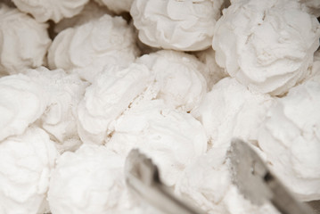 Marshmallows on a shelf in a supermarket. Lots of round marshmallows. Soft focus