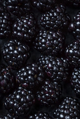 Blackberry Background. Closeup of fresh blackberries  on black textured  background, top view