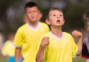 Young children players football match on soccer field