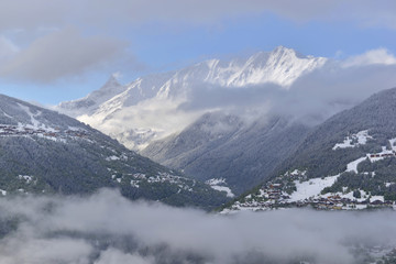 view on clouds and peak mountain covered with snow 