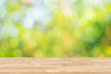 Top of wood table empty ready for your product and food display or montage background with bokeh green abstract background.