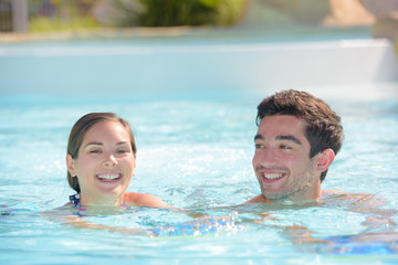 Man and woman swimming in pool