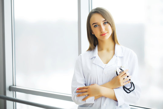 Health Care. Female doctor standing in hospital corridor. Medical Concept