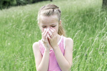 allergic - unhappy child with grasses allergy in the meadow
