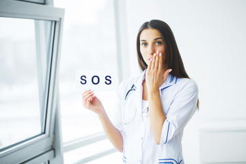Health Care. Doctor Holding a Card With Symbol HELP, Medical Concept