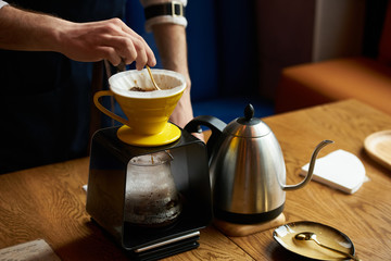 Bartender Hand drip coffee , Barista pouring water on coffee ground with paper filter