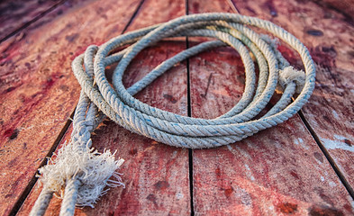 Rope on the grunge wood. Sail boat close-up.