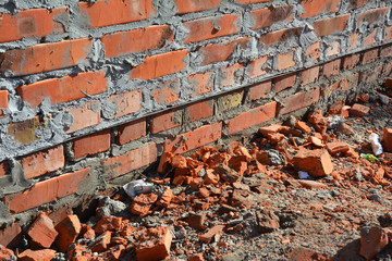 Close up on bitumen waterproofing membrane on brick house wall foundation.