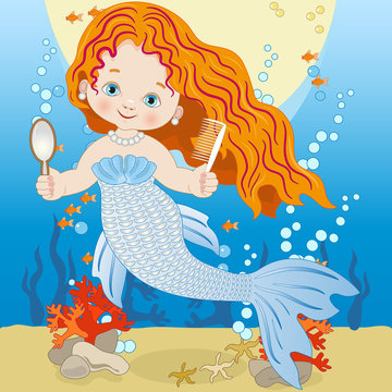 Small mermaid with comb and mirror on the seabed