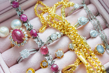 Gold and silver diamond gemstone sapphire ring necklaces and pearl earrings in luxury jewelry box