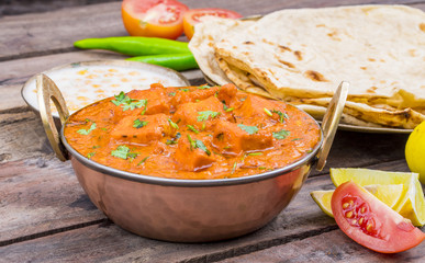 Indian Delicious Cuisine Paneer Tikka Masala With Tandoori Chapati Also Called Paneer Butter Masala is an Indian Dish of Marinated Paneer Cheese Served in a Spiced Gravy on Wooden Background