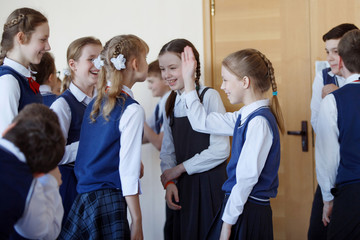 Fototapeta na wymiar Group of elementary school kids standing in school corridor