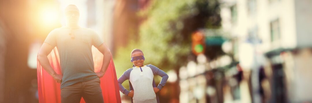 Composite image of father and son pretending to be superhero