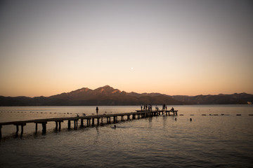 Fototapeta premium People on the wooden pier