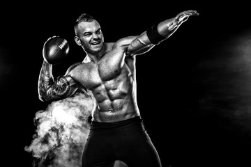 Sport concept. American football sportsman player on black background. Sport concept.