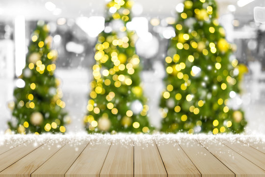 Empty top of blur Christmas-tree background and Christmas decorations with snow, bokeh. Happy New Year and Xmas theme.For product display
