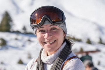 Happy woman portrait against a beautiful background of snow.