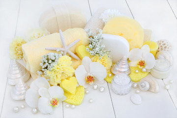 Beauty treatment cleansing and ex foliation products with orchid & carnation flowers, ex foliating salt, heart shaped  soaps, moisturising cream, sponges, wash cloths, loofah, seashells and pearls . 