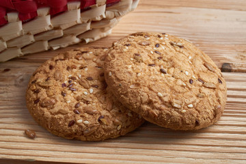 Savory cookies sprinkled with sesame seeds, sunflower on table and burlap background