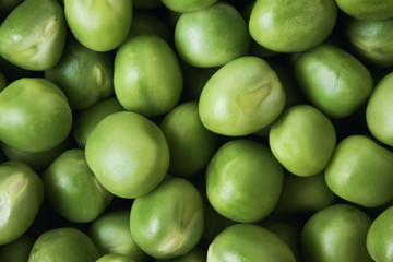 Pile of fresh raw green peas background. Top view