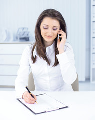 business woman discussing work documents on a mobile phone