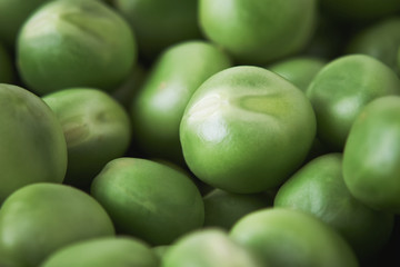 Closeup pile of fresh raw green peas, selective focus