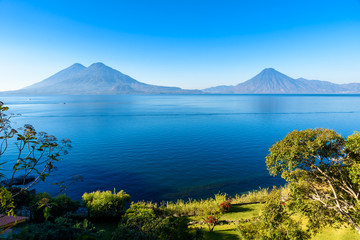 View from Lake Atitlan in the early morning, beautiful magic lake with volcanos and indigenous...