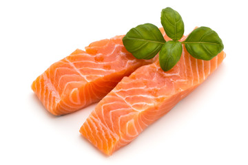 Fresh salmon fillet with basil on the white background.