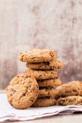 Chocolate oatmeal cookies on the wooden background.