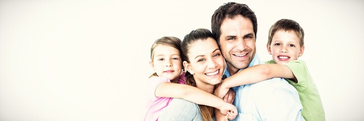 Obraz premium Portrait of smiling parents giving piggy-back to children 