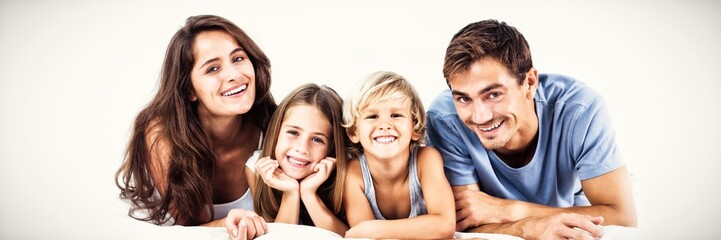 Happy family lying on a bed