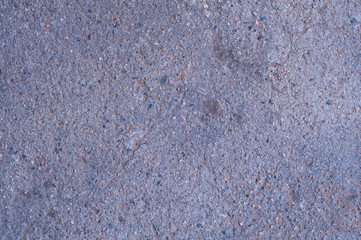 Gray worn cement surface with gravel. Background