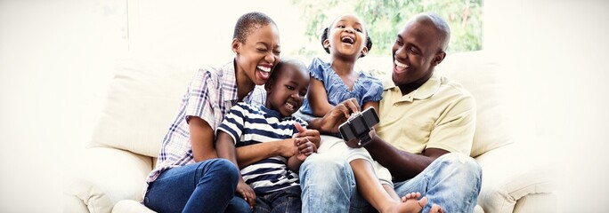 Happy smiling family on couch 