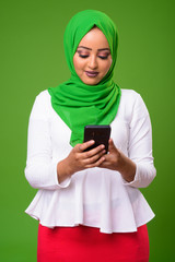 Young African Muslim woman against chroma key with green background