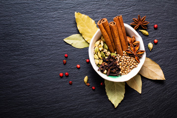 Exotic herbal Food concept Mix of the organic Spices cinnamon stick, cardamom pods, bay leaves,...