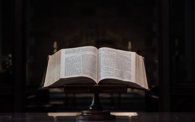 Bible on stand in church open to the book of Jonah