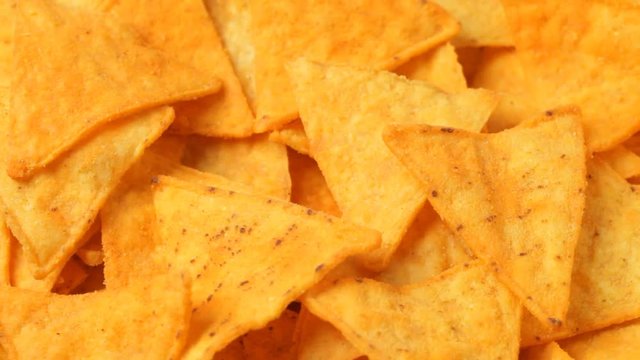 Close up of rotating nacho chips. No sound.