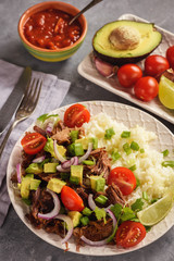 Pulled lamb with boiled rice and vegetables.